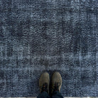 1970s black vintage Turkish overdyed rug with overdyed design, hand-knotted weave and low pile.