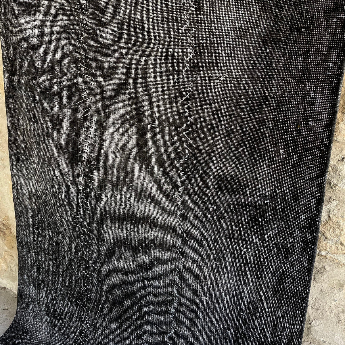 1970s black vintage Turkish overdyed rug with overdyed design, hand-knotted weave and low pile.