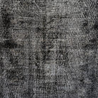 Black 4' x 7' vintage Turkish overdyed rug in wool and cotton, shown on the floor.
