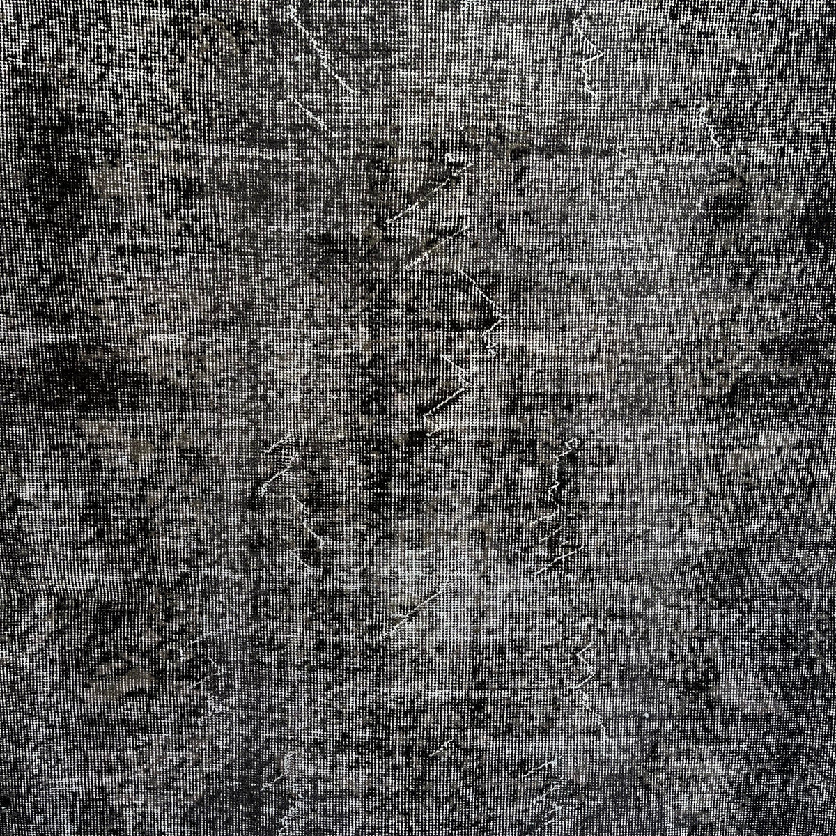 Black 4' x 7' vintage Turkish overdyed rug in wool and cotton, shown on the floor.