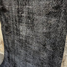 1970s black vintage Turkish overdyed rug with overdyed design, hand-knotted weave and low pile.