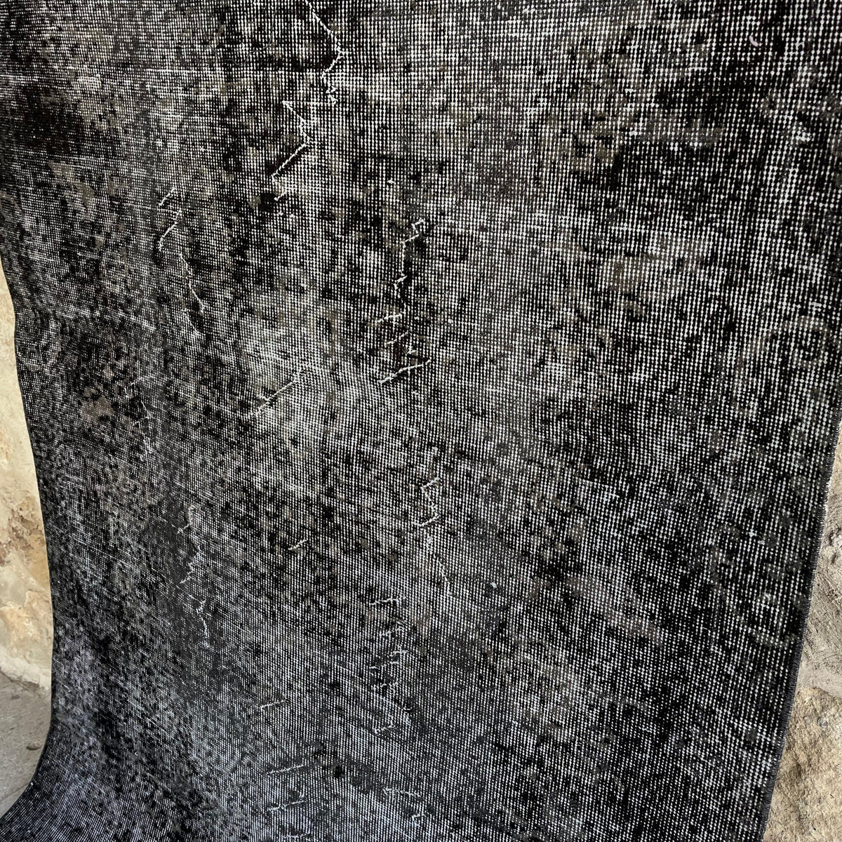 1970s black vintage Turkish overdyed rug with overdyed design, hand-knotted weave and low pile.