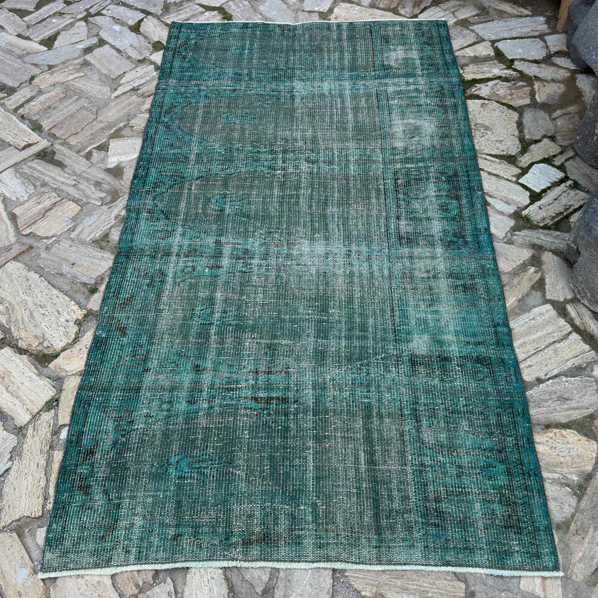 Blue 4' x 7' vintage Turkish overdyed rug in wool and cotton, shown on the floor.