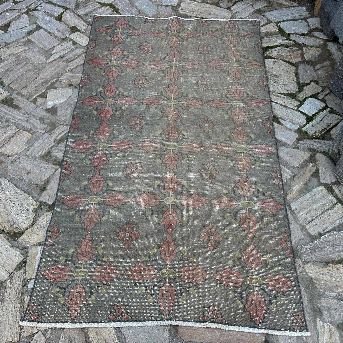 Gray 4' x 7' vintage Turkish overdyed rug in wool and cotton, shown on the floor.