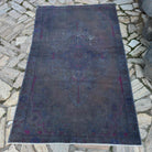 Grey 4' x 7' vintage Turkish overdyed rug in wool and cotton, shown on the floor.