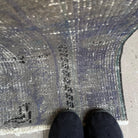 Close-up of the gray vintage Turkish overdyed rug showing overdyed details, hand-knotted weave, wool and cotton and low pile.
