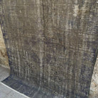 Gray 5' x 7' vintage Turkish overdyed rug in wool and cotton, shown on the floor.
