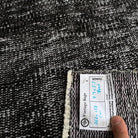 1970s black vintage Turkish overdyed rug with overdyed design, hand-knotted weave and low pile.