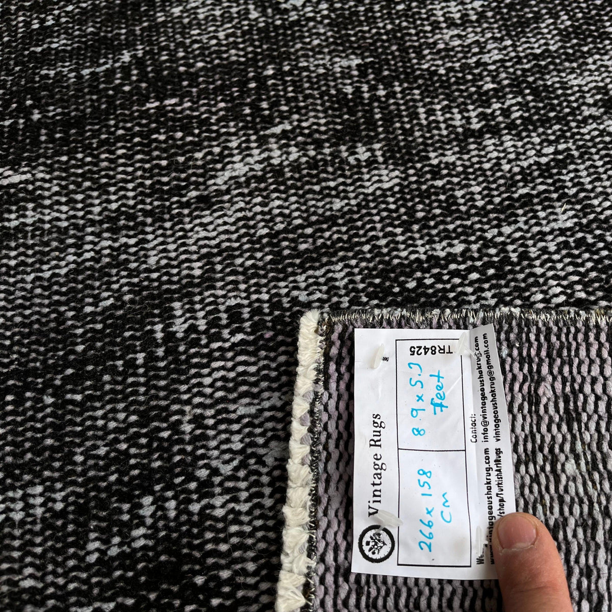 1970s black vintage Turkish overdyed rug with overdyed design, hand-knotted weave and low pile.