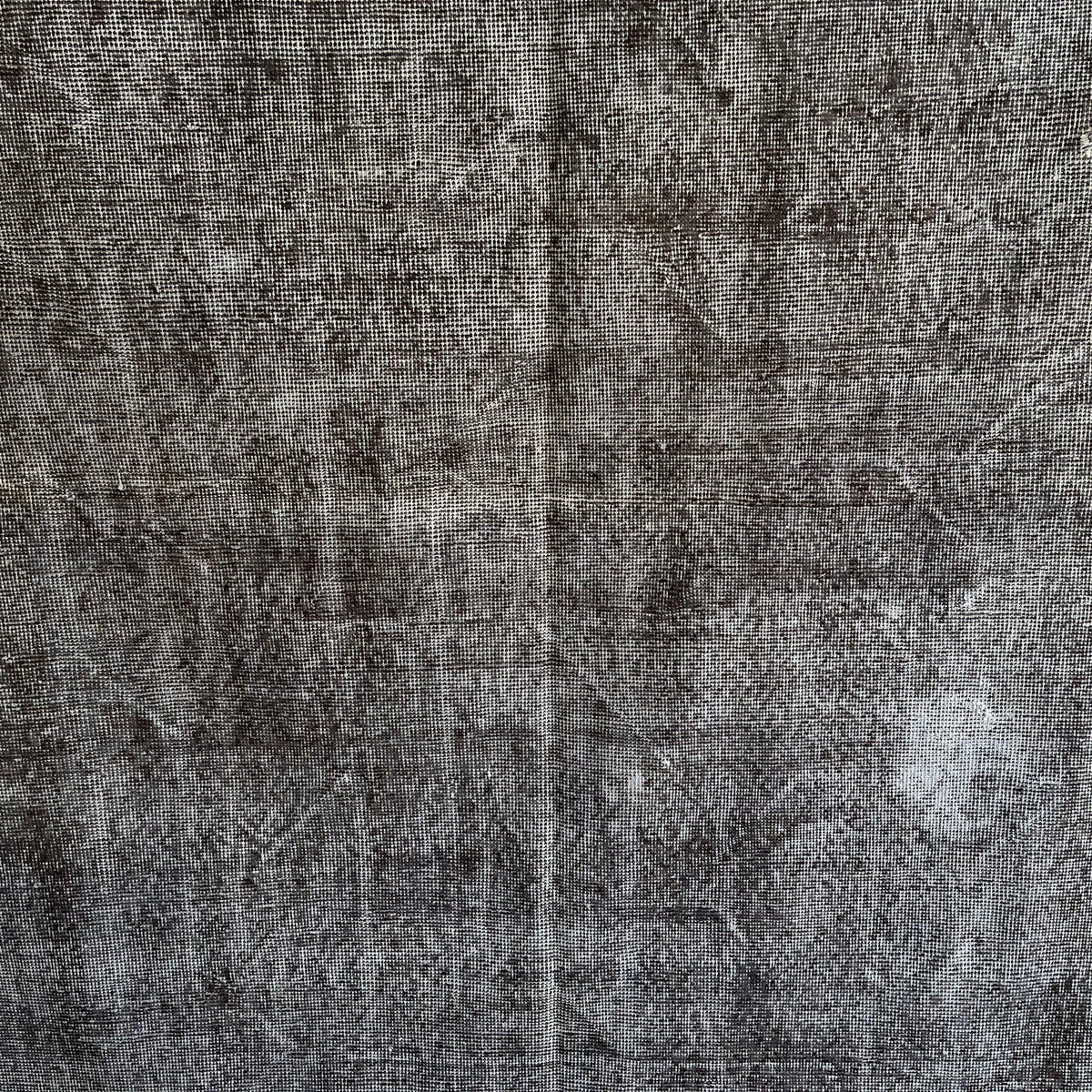 Gray 5' x 9' vintage Turkish overdyed rug in wool and cotton, shown on the floor.