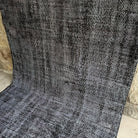 Gray 5' x 9' vintage Turkish overdyed rug in wool and cotton, shown on the floor.