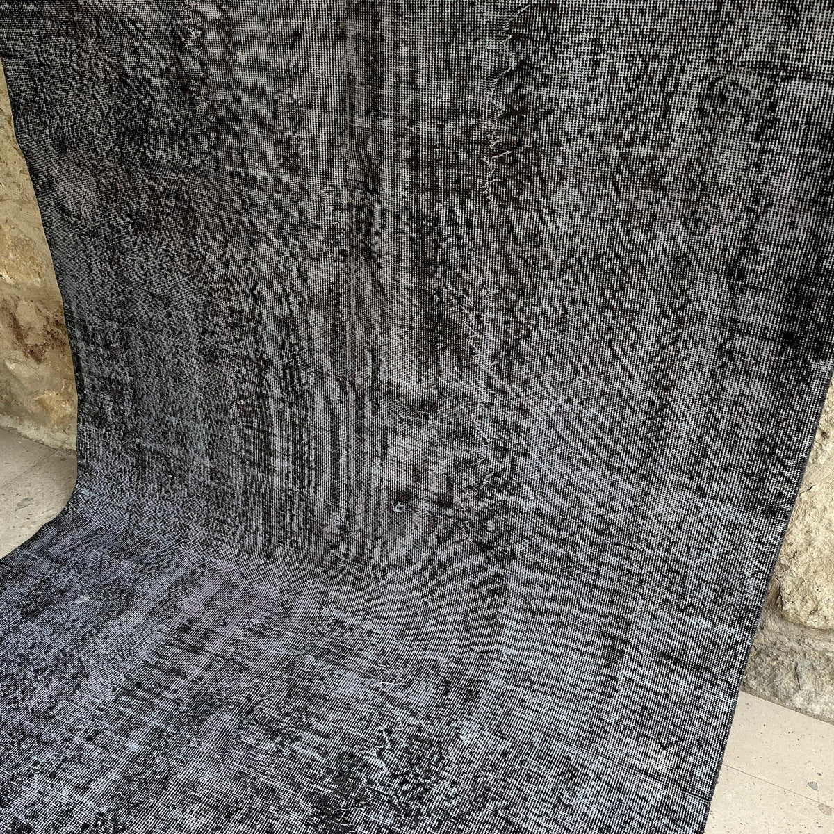 Gray 5' x 9' vintage Turkish overdyed rug in wool and cotton, shown on the floor.