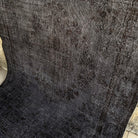 Black 6' x 9' vintage Turkish overdyed rug in wool and cotton, shown on the floor.