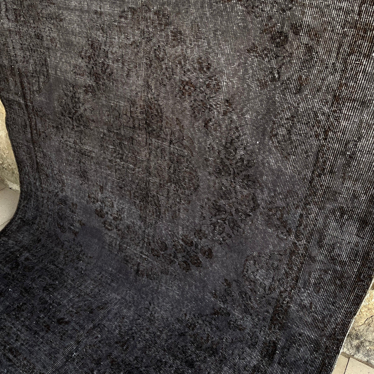 Black 6' x 9' vintage Turkish overdyed rug in wool and cotton, shown on the floor.