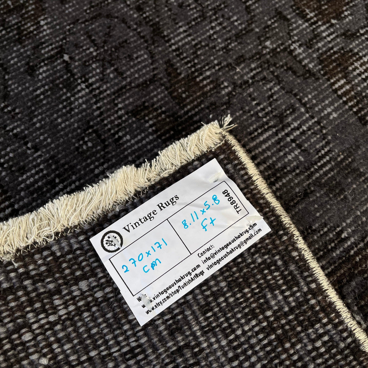 1970s black vintage Turkish overdyed rug with overdyed design, hand-knotted weave and low pile.