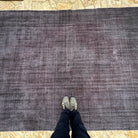 1970s black vintage Turkish overdyed rug with overdyed design, hand-knotted weave and low pile.