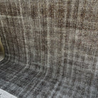 Black 8' x 9' vintage Turkish overdyed rug in wool and cotton, shown on the floor.