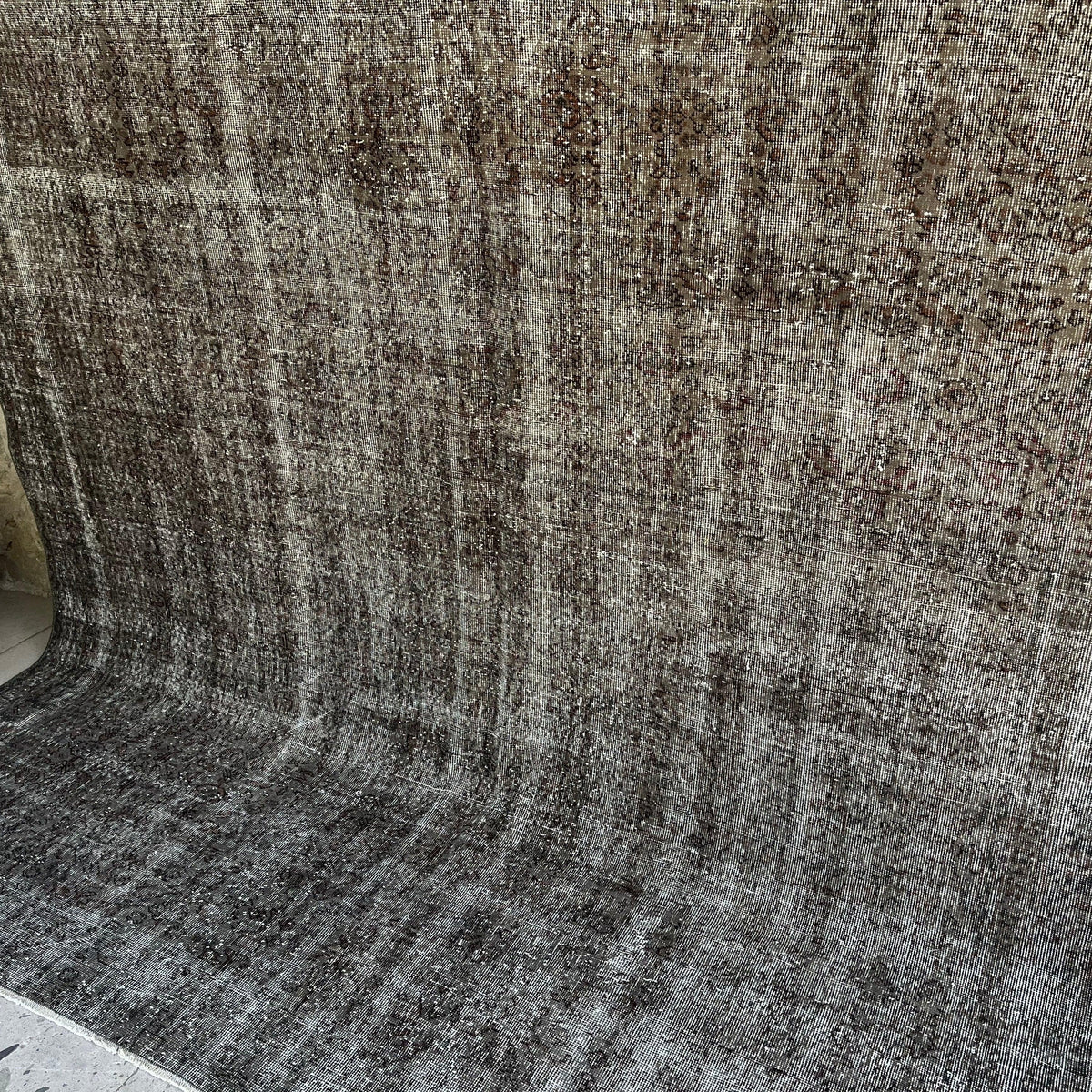 Black 8' x 9' vintage Turkish overdyed rug in wool and cotton, shown on the floor.