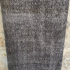Gray 2' x 9' vintage Turkish overdyed runner rug in wool and cotton, shown on the floor.
