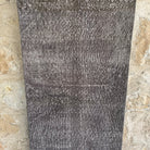 Gray 2' x 9' vintage Turkish overdyed runner rug in wool and cotton, shown on the floor.