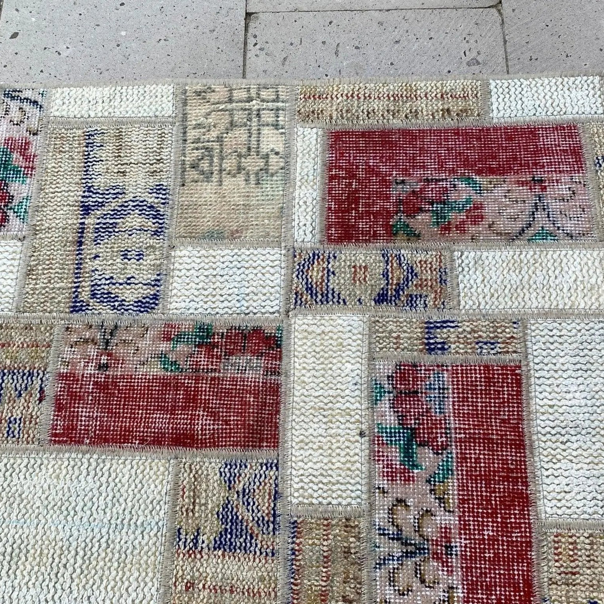1970s red vintage Turkish patchwork rug with patchwork design, hand-knotted weave and low pile.