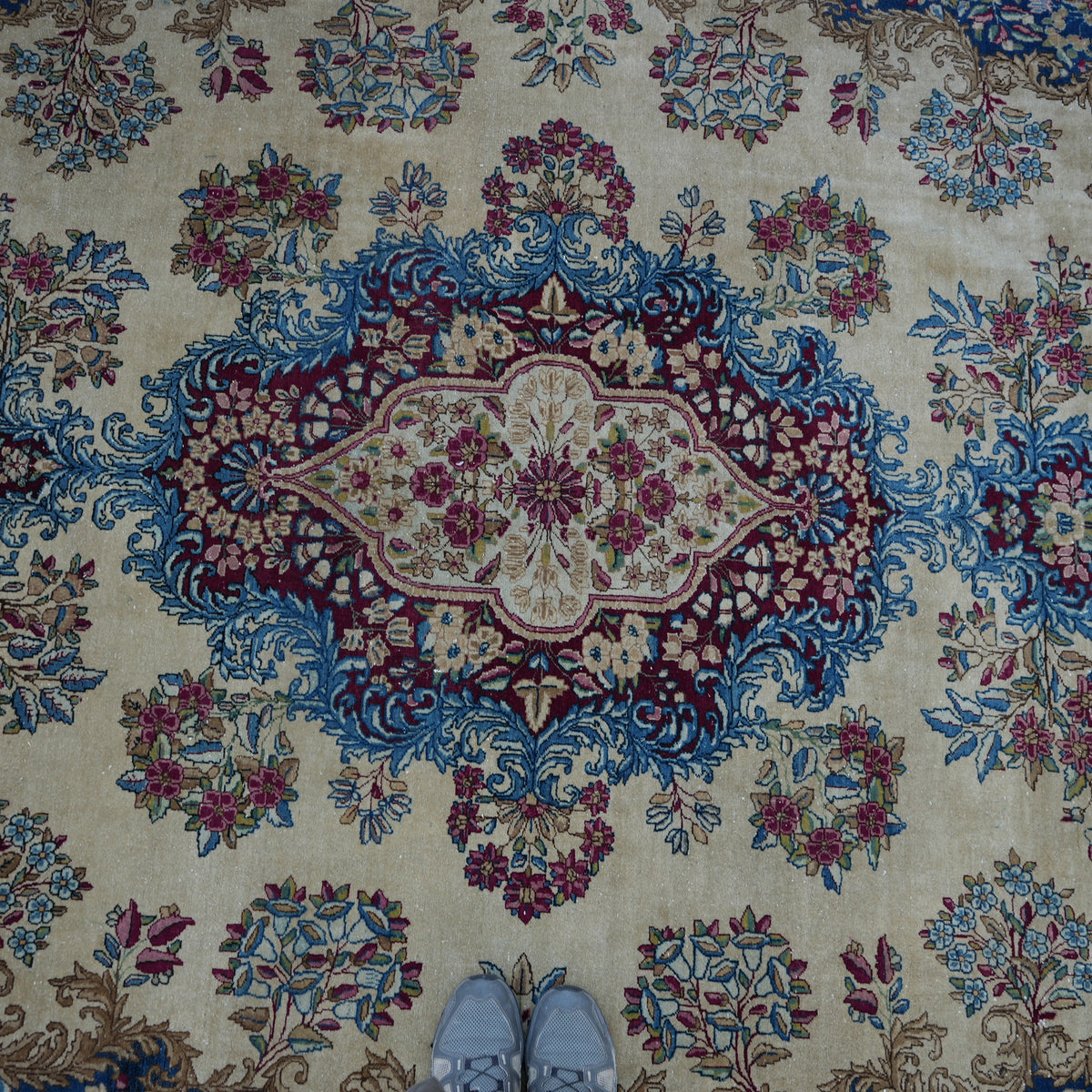 Colorful 10' x 14' vintage persian rug in wool and cotton, shown on the floor.