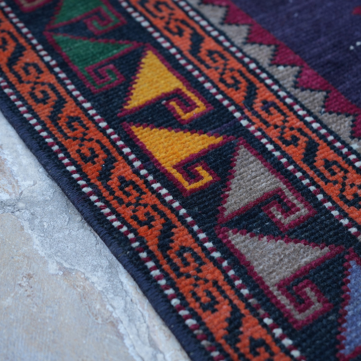 Purple 4' x 10' vintage Turkish persian rug in wool and cotton, shown on the floor.