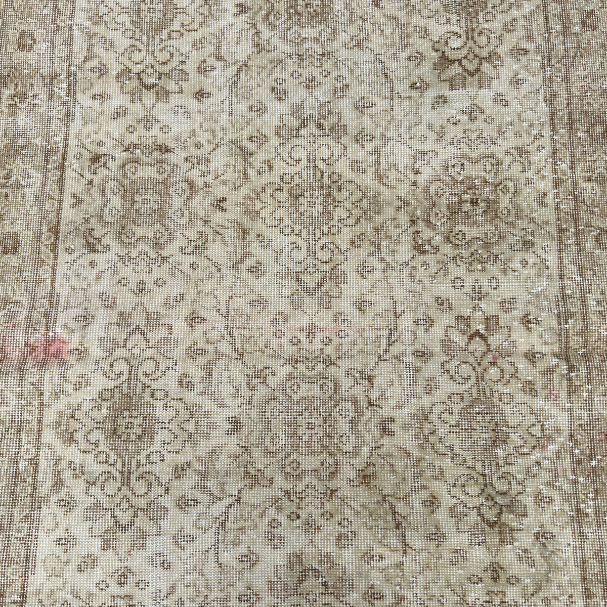 1970s beige vintage persian rug with floral design, hand-knotted weave and low pile.
