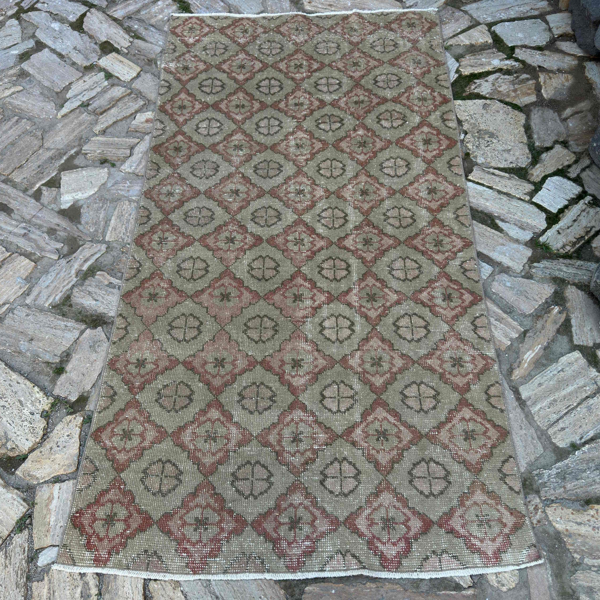 Beige 4' x 7' vintage Turkish persian rug in wool and cotton, shown on the floor.