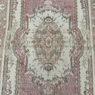 1970s pink vintage Turkish persian rug with medallion design, hand-knotted weave and low pile.