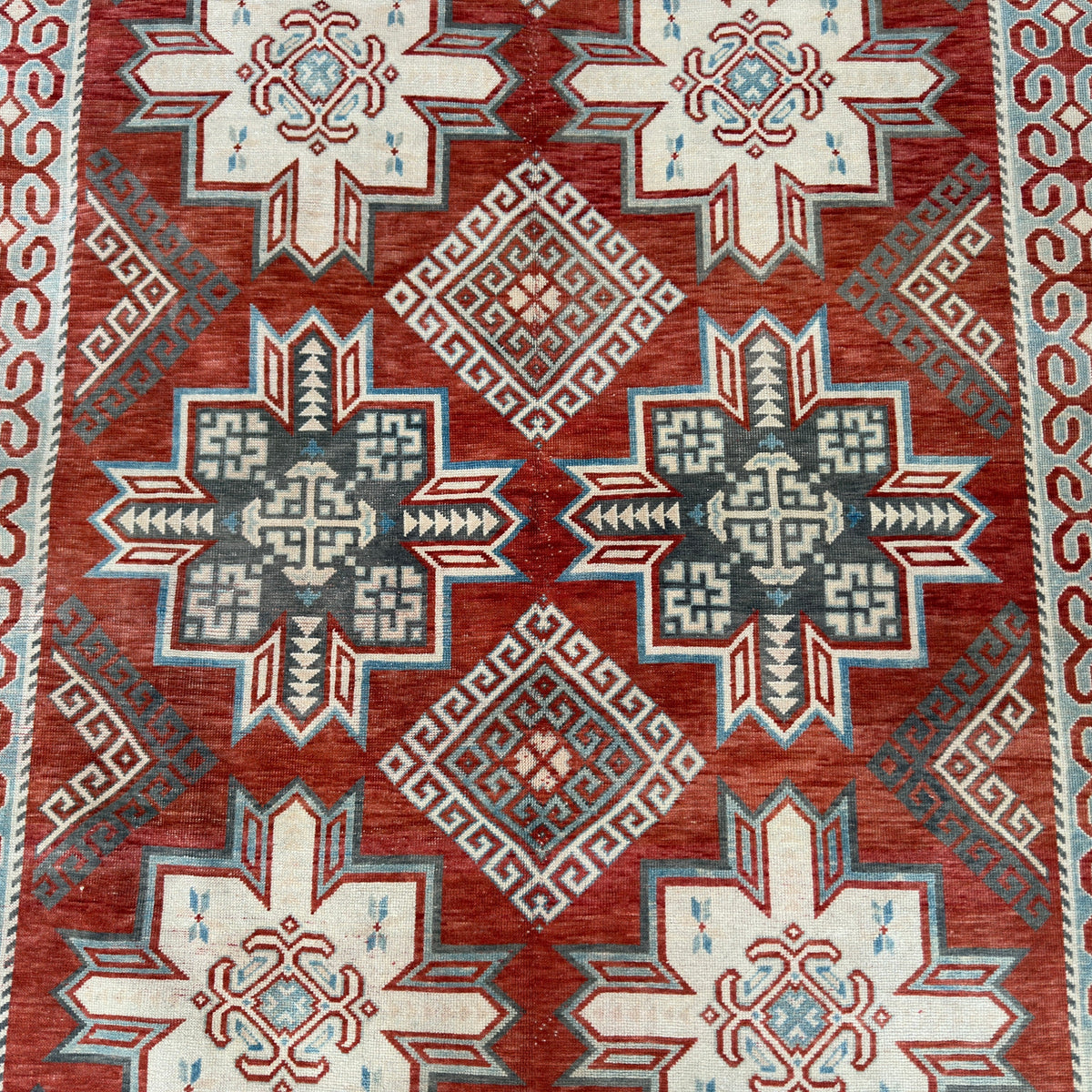 1970s red vintage persian rug with traditional design, hand-knotted weave and low pile.