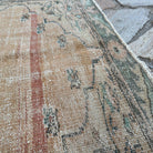 Close-up of the red vintage Turkish persian rug showing medallion details, hand-knotted weave, wool and cotton and low pile.