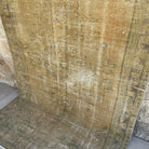 Beige 5' x 9' vintage Turkish persian rug in wool and cotton, shown on the floor.