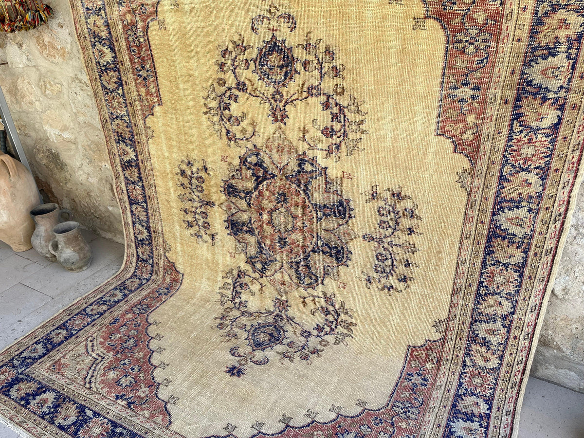 Blue 6' x 10' vintage Turkish persian rug in wool and cotton, shown on the floor.