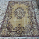 Yellow 6' x 8' vintage Turkish persian rug in wool and cotton, shown on the floor.