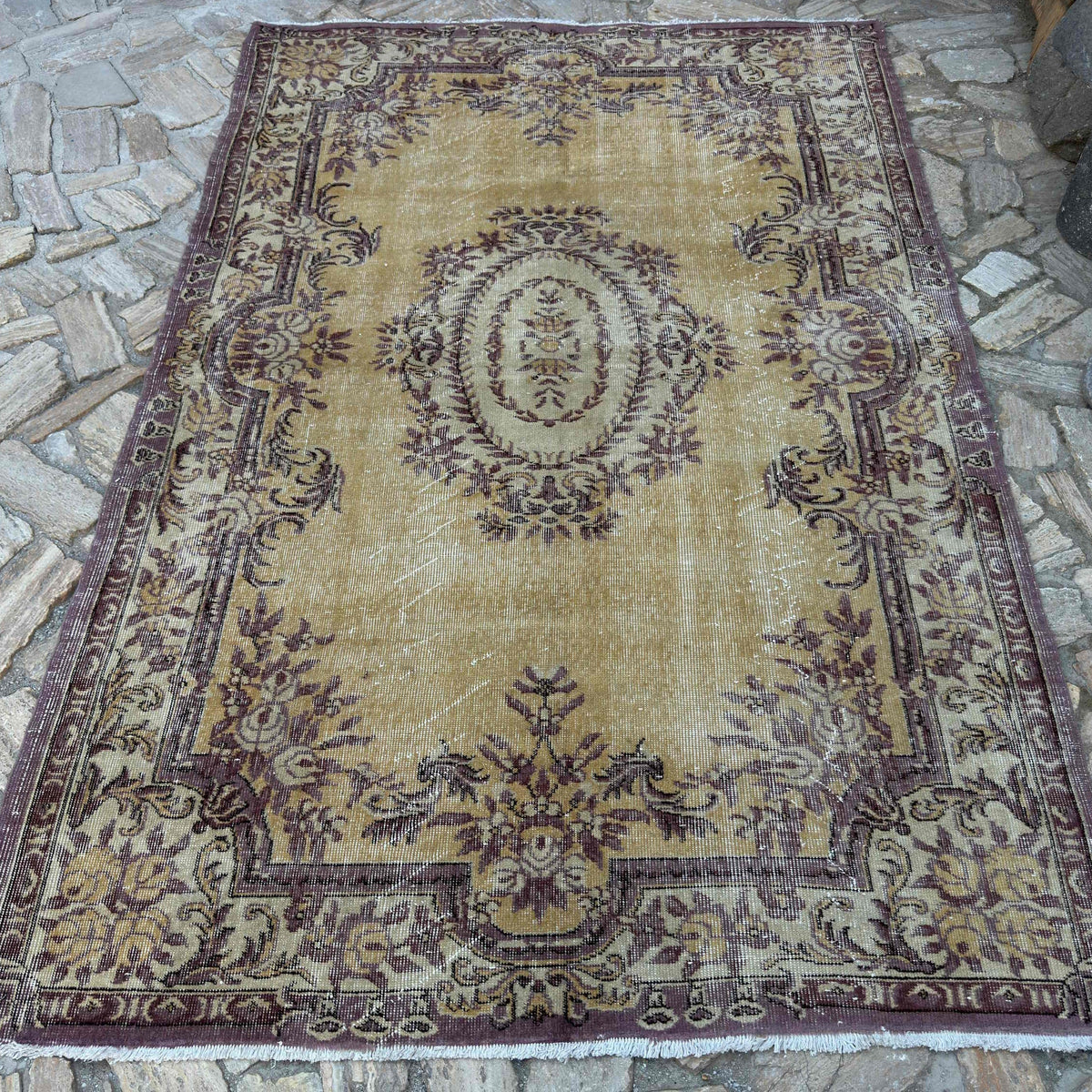 Yellow 6' x 8' vintage Turkish persian rug in wool and cotton, shown on the floor.
