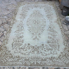 Beige 6' x 9' vintage Turkish persian rug in wool and cotton, shown on the floor.