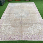 Beige 7' x 11' vintage Turkish persian rug in wool and cotton, shown on the floor.