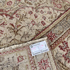 Close-up of the red vintage Turkish persian rug showing medallion details, hand-knotted weave, wool and cotton and low pile.