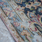 1970s red vintage persian rug with floral design, hand-knotted weave and low pile.