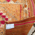 Close-up of the orange vintage persian runner rug showing traditional details, hand-knotted weave, wool and cotton and medium pile.
