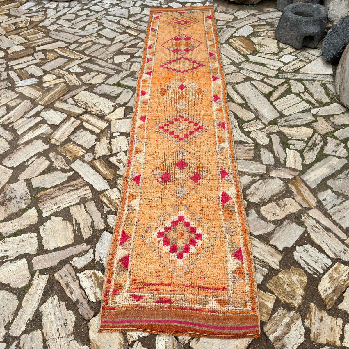Orange 2' x 12' vintage persian runner rug in wool and cotton, shown on the floor.