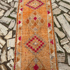 1970s orange vintage persian runner rug with traditional design, hand-knotted weave and medium pile.