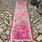 Pink 3' x 11' vintage persian runner rug in wool and cotton, shown on the floor.