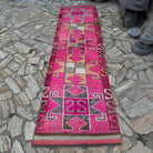 Pink 3' x 11' vintage persian runner rug in wool and cotton, shown on the floor.