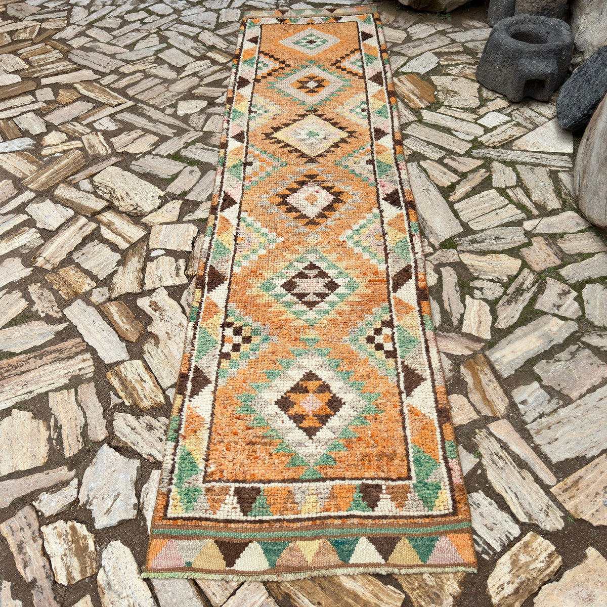 Orange 3' x 12' vintage persian runner rug in wool and cotton, shown on the floor.