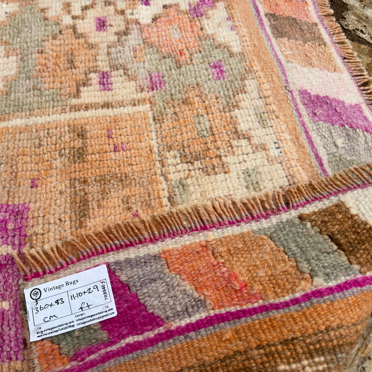 Close-up of the pale orange vintage persian runner rug showing traditional details, flatweave construction, wool and cotton and low pile.