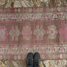 Pink 3' x 12' vintage persian runner rug in wool and cotton, shown on the floor.