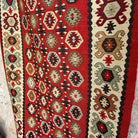 Close-up of the red vintage Turkish persian runner rug showing traditional details, flatweave construction, wool and cotton and low pile.