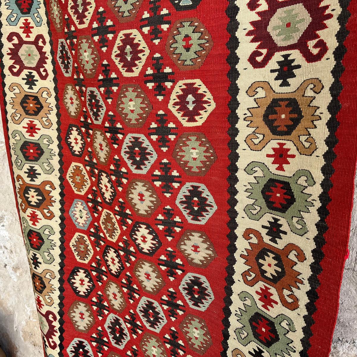 Close-up of the red vintage Turkish persian runner rug showing traditional details, flatweave construction, wool and cotton and low pile.